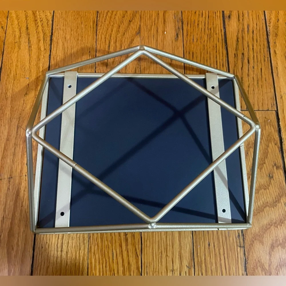 Mirror with geometric metalwork